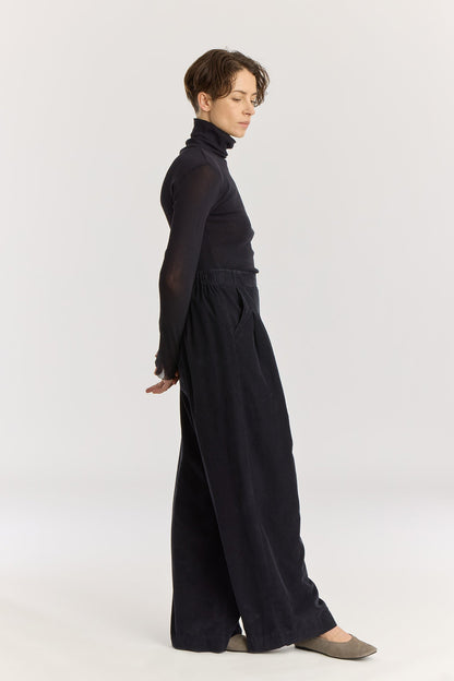 Wide Pleated Pants / Dark Navy
Elastic waist
Pleated detail at the front
Slash pockets
Wide shape
100% Cotton baby corduroy
Machine wash in cold water, tumble dry low, no bleach
Style number: BC-LWP05
Regular fit
Made in USA
Woman wearing dark navy wide-leg baby corduroy pants with front pleats, elastic waistband, and slash pockets.